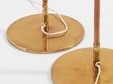 pair of brass table lamps with a rope on each of them