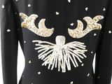 the back of a black jacket with gold and white sequins on it