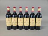 six bottles of red wine lined up in a row