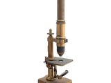 a close up of a microscope on a stand on a white background