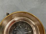an overhead view of a gold plated light fixture with a clear glass lens