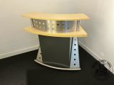 an image of a corner desk in the corner of a room