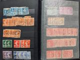 many different stamps in a folder on the table
