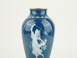 a blue vase with a picture of a woman on it