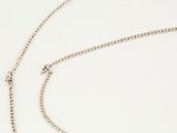 a close up of a chain on a white surface