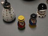 three salt and pepper shakers sitting on a table