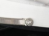 a close up picture of a white hat with a coin on it