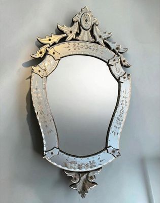 a mirror hanging on the wall with a bird on it