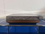 an old stereo player sitting on top of a blue shelf