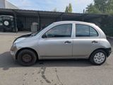 a small silver car that is parked in a parking lot