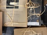 several books are wrapped in brown paper and tied up with twine