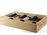 bottles of wine in a wooden box on a white surface