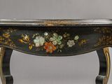 a black table with a floral design on it