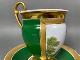 a green and white cup and saucer on a saucer