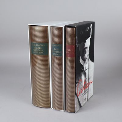 two books are stacked on top of each other on a gray surface