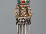 a glass bottle with a gold and blue decoration on it