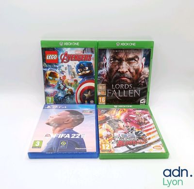 three video games on display on a white surface
