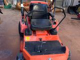 a lawn mower that is sitting in a garage