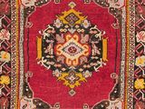 a close up of a red rug with a medallion design on it