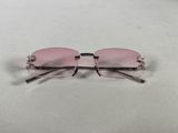a pair of pink sunglasses sitting on top of a white surface