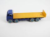 a toy truck that is blue and yellow on a white background