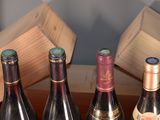 several bottles of wine are lined up on a table
