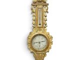 an image of a gold clock mounted to the side of a wall