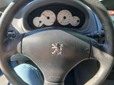 a steering wheel and dashboard of a car with a clock on it