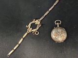 two antique silverware items including a knife, pocket watch and a stick