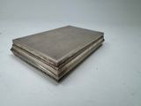 an antique silver cigarette case on a white surface