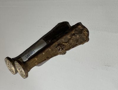 a small metal object on a white surface
