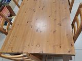 a wooden table and chairs in a room with tile flooring