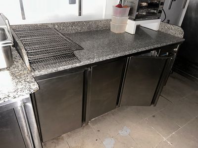 an image of a kitchen with stainless steel appliances and granite counter tops