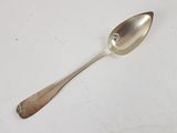 silver spoon with a diamond on it sitting on a white surface