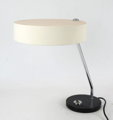 a white lamp that is sitting on a table