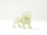 une figurine blanche représentant un chien avec une fleur sur la tête