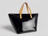 a black and white tote bag sitting on top of a white surface
