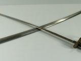 two swords are sitting on a table with a white surface