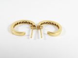 a pair of gold hoop earrings on a white background