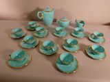 many tea cups and saucers sitting on a table