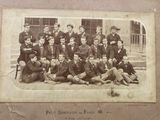 an old photo of a group of men posing for a picture