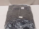 a bag of clothing wrapped in plastic on a table