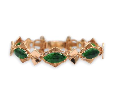 une photo d'un bracelet en or orné de pierres vertes