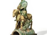 statue of a man sitting on a horse with a dog on the back