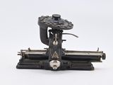 an old sewing machine that is sitting on a white surface
