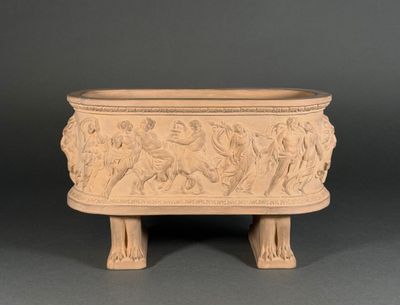 an old stone planter with carvings on the sides of it