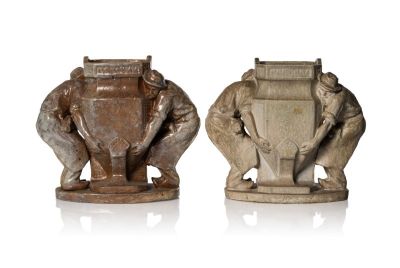 two statues of elephants holding a shield and a shield with a shield on it