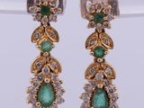an image of a pair of earrings with green stones
