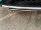 a close up of a car ' s grille with a sticker on it