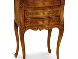 an image of a small wooden chest of drawers on a white background